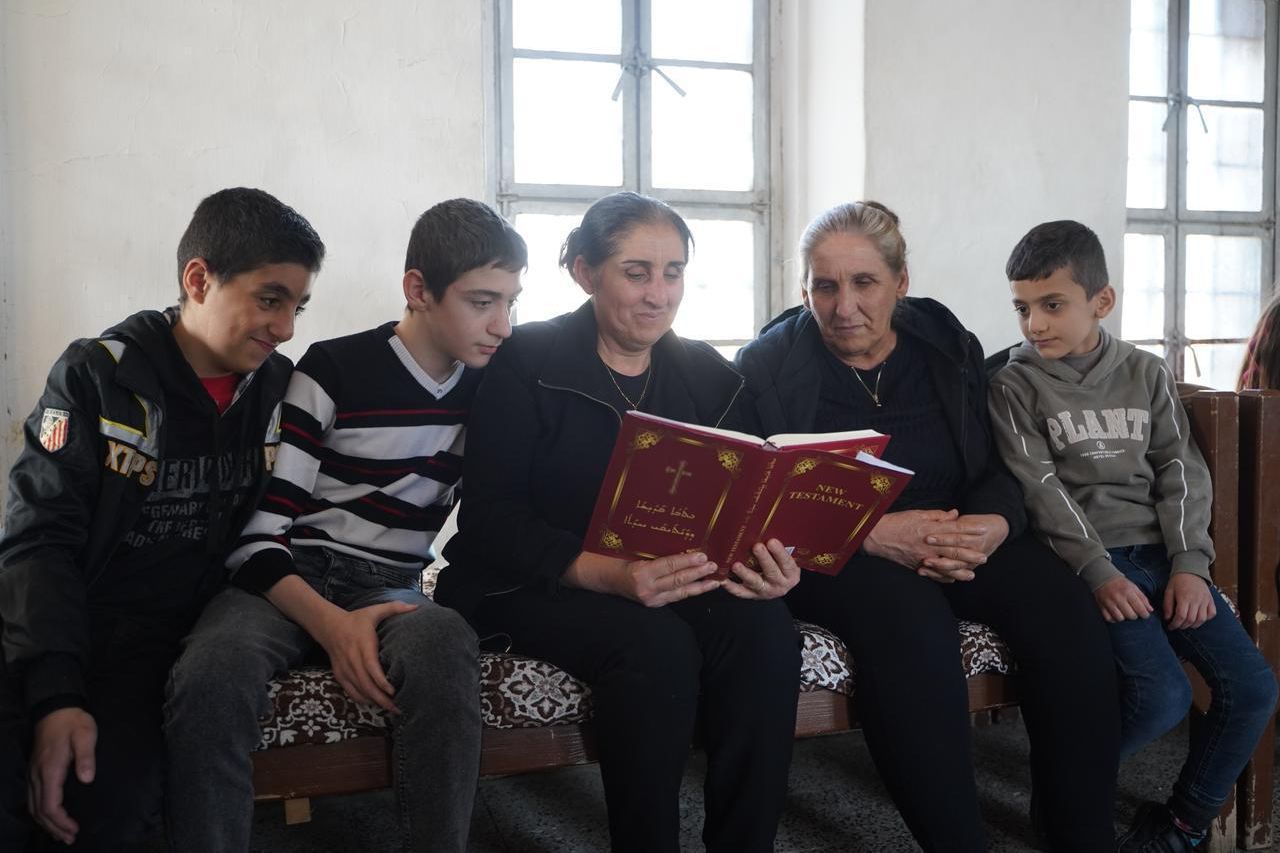 Family gathered with a bible