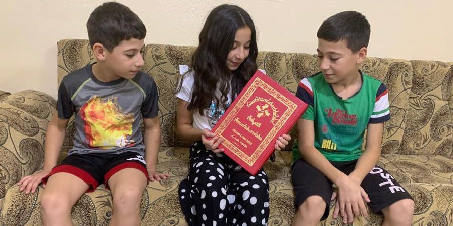 Family gathered with a bible
